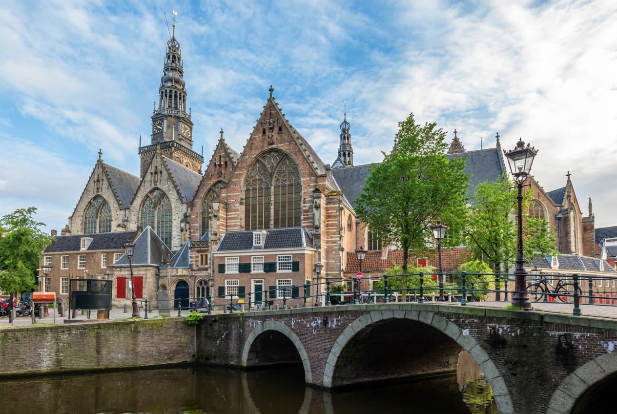 A church tower beside an Amsterdam canal.