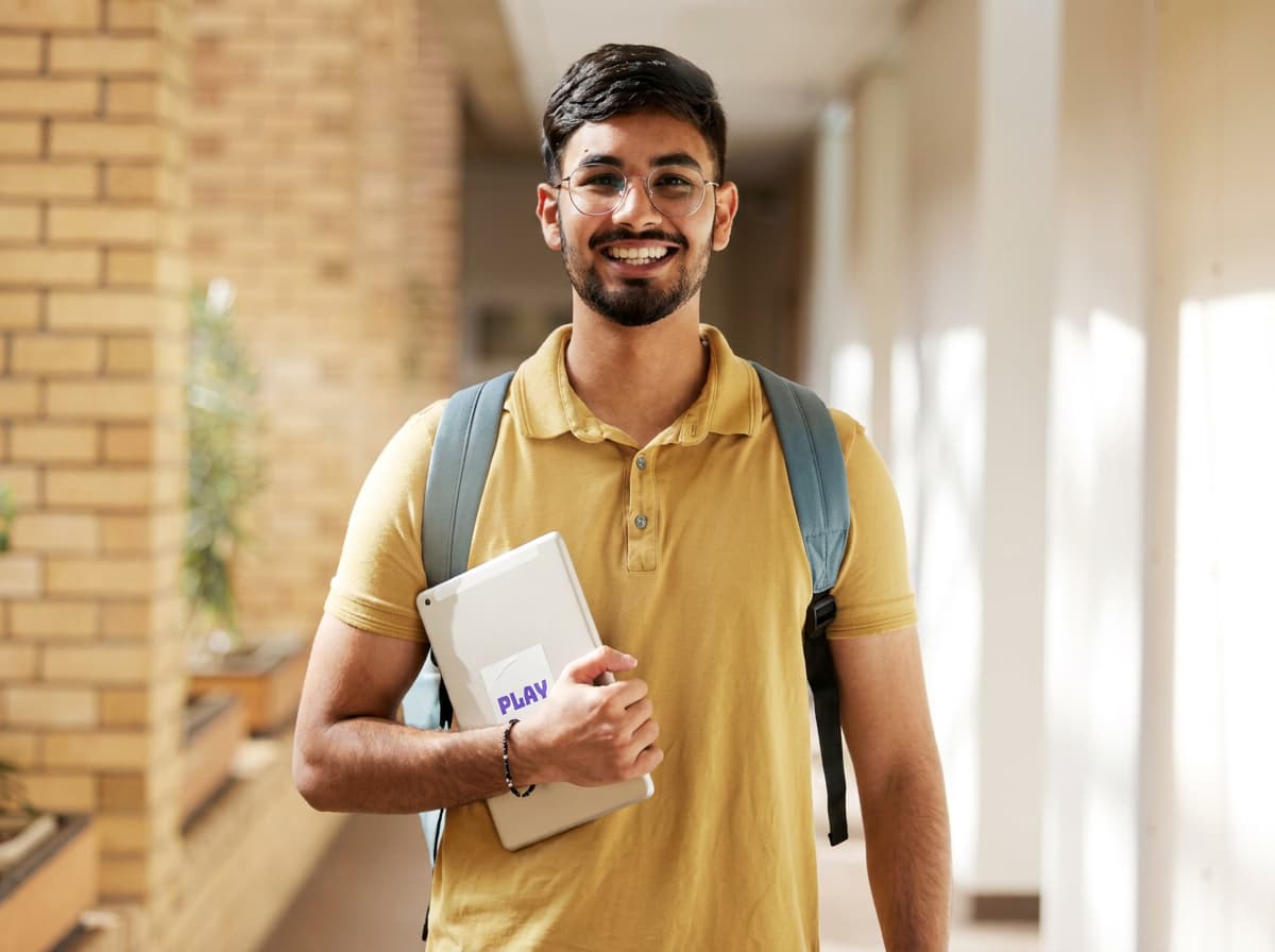 A student holding a tablet, preparing study visa documents.