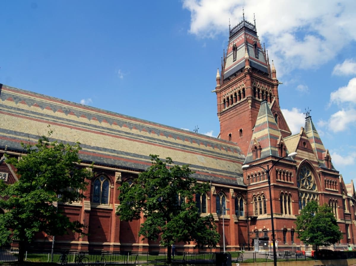 A historic red-brick university building with a clock tower on a US campus.