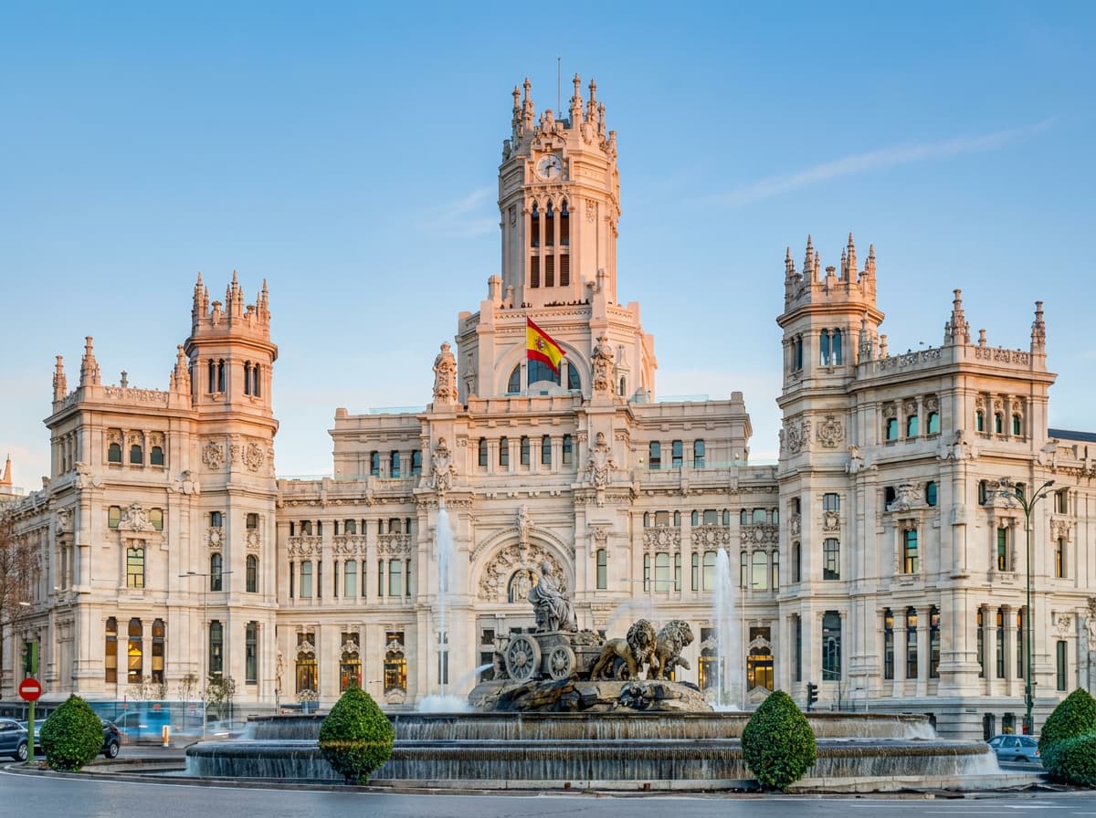 The Cibeles Palace and fountain in Madrid in warm light.